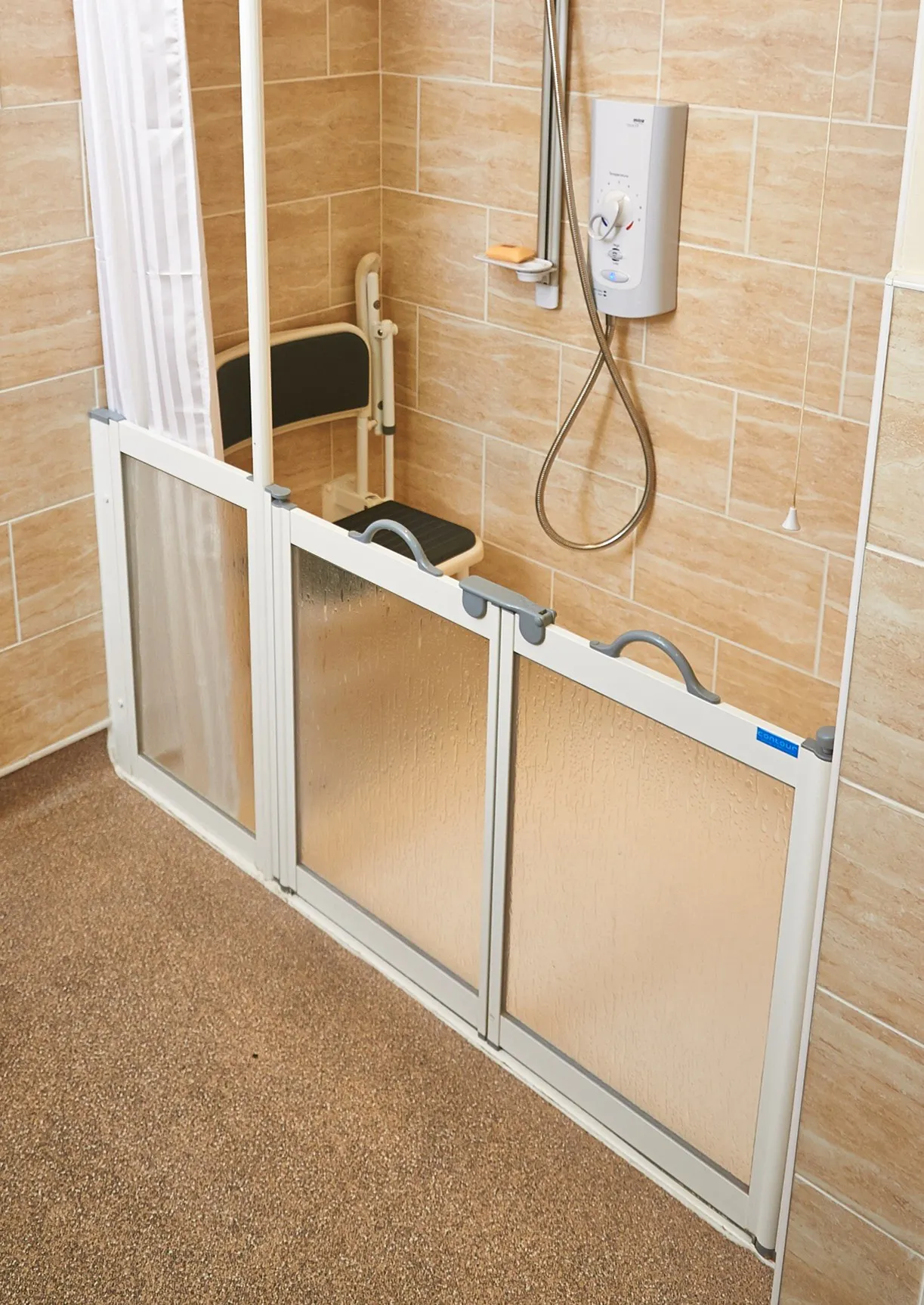 Small disabled shower room layout with shower seat, level access tray and mobility support features