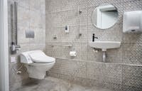 Disabled toilet installation with wall-mounted wash and dry toilet, grab rails and adapted basin at the More Ability Harrogate showroom.