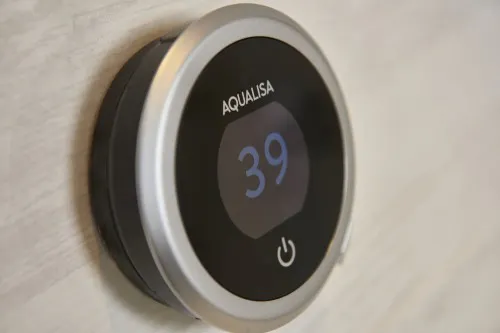 Digital shower control with illuminated temperature display, providing accessible and easy-to-use bathroom technology.