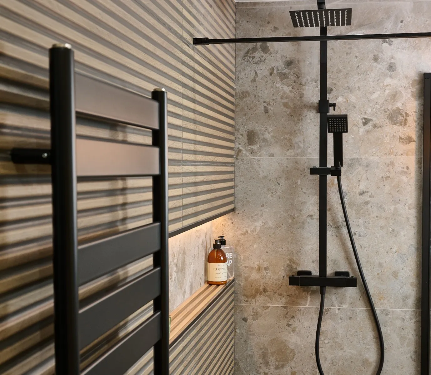 Modern black heated towel rail as a stylish bathroom heating option