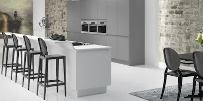 Minimalist contemporary kitchen with sleek island breakfast bar and integrated appliances.